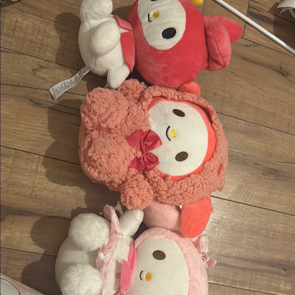 Pink and Red Stuffed Animals with Round Bodies and Small Dark Eyes